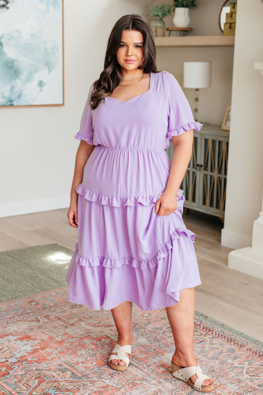 Plus size lavender tiered ruffle dress with puff sleeves and sweetheart neckline.