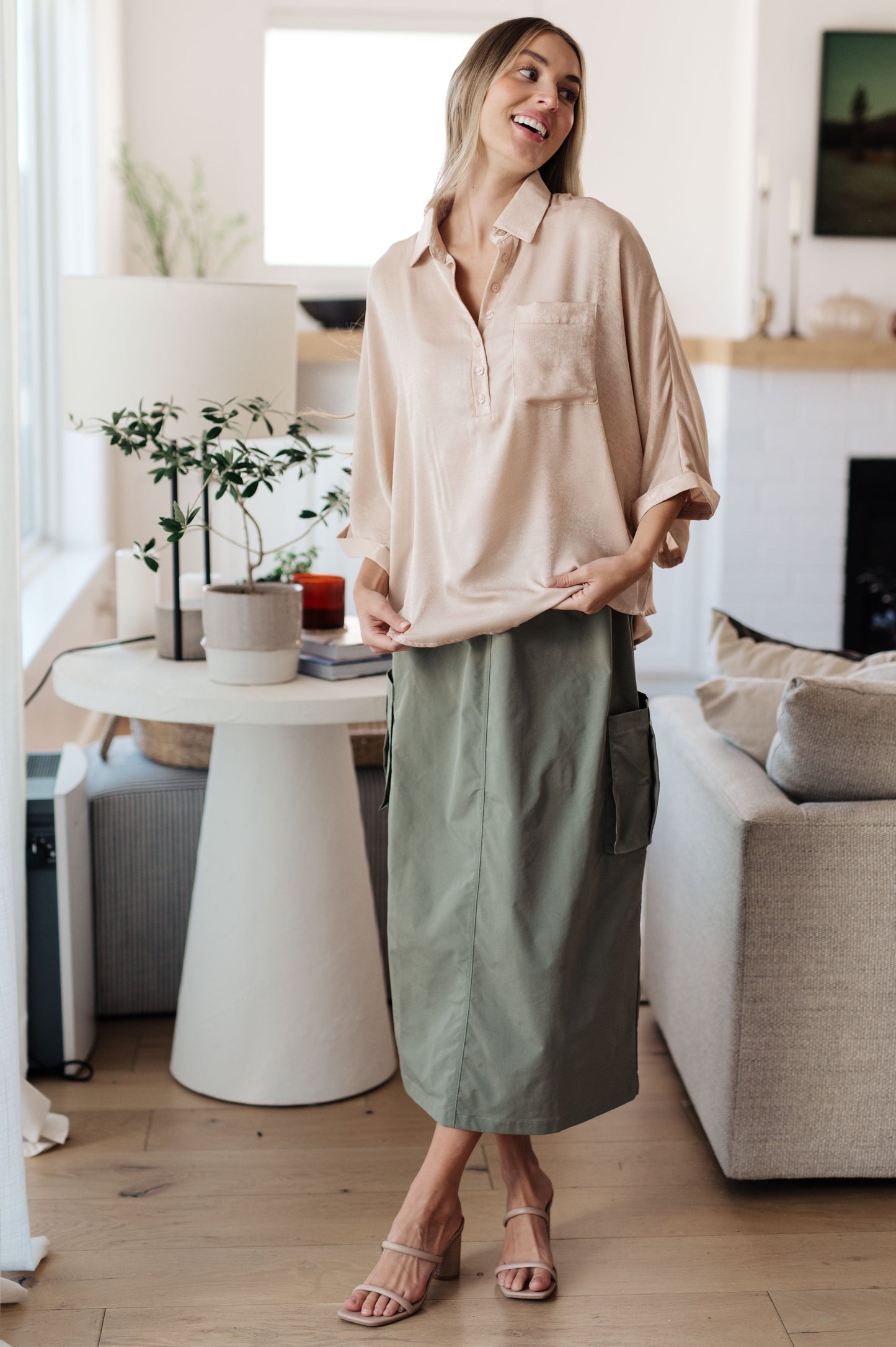 Full body front view of Ruth Oversized Dolman Sleeve Top in champagne with green skirt