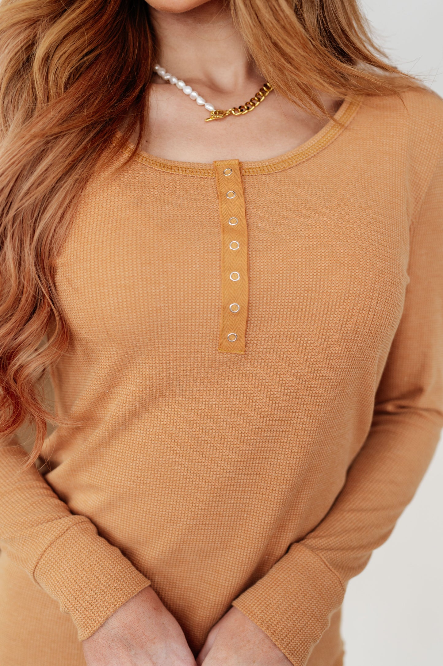 Close-up of Clara Long Henley showing snap-up henley design and soft waffle knit fabric.