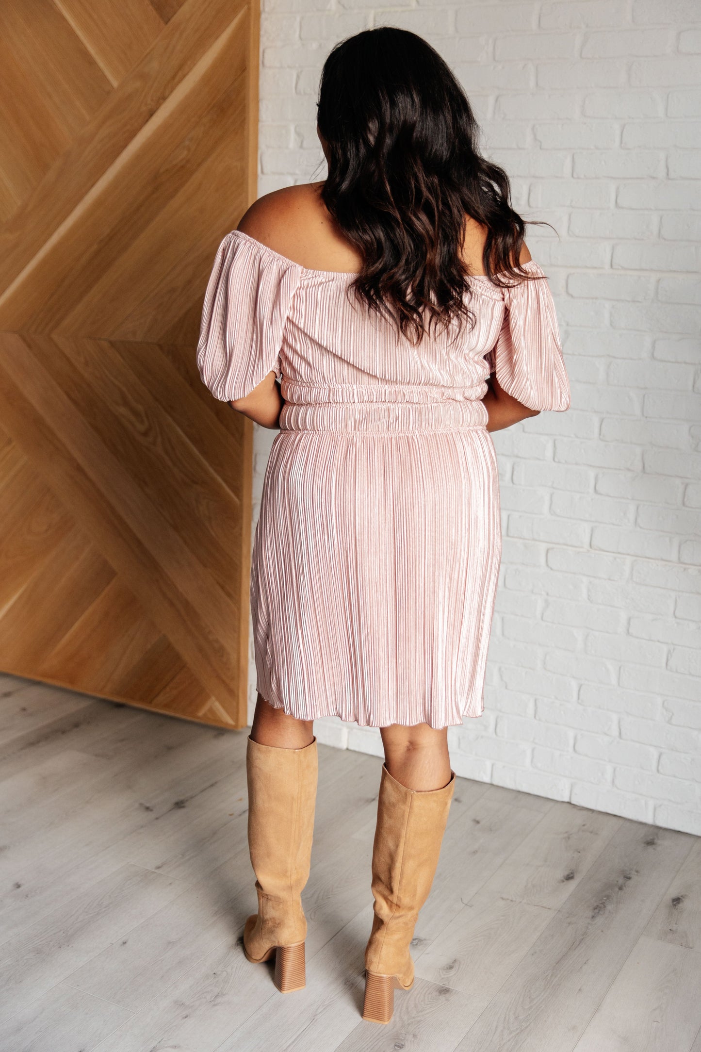 Back view of plus size Astrid Balloon Sleeve Dress in pink satin plissé with elastic waistline.