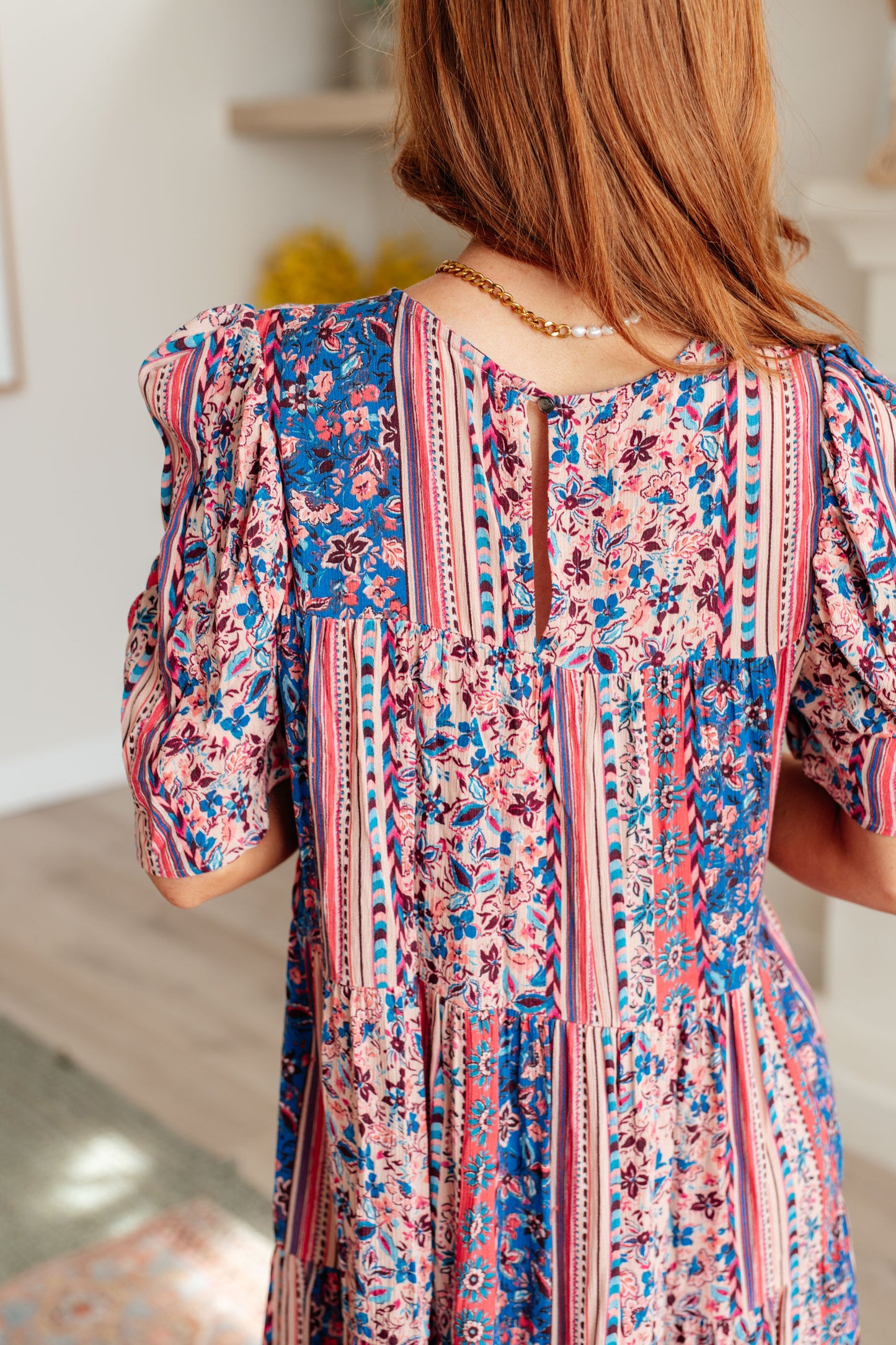 Close-up back view of Rylee Tiered Dress in pink-and-blue floral print showing rear keyhole closure.