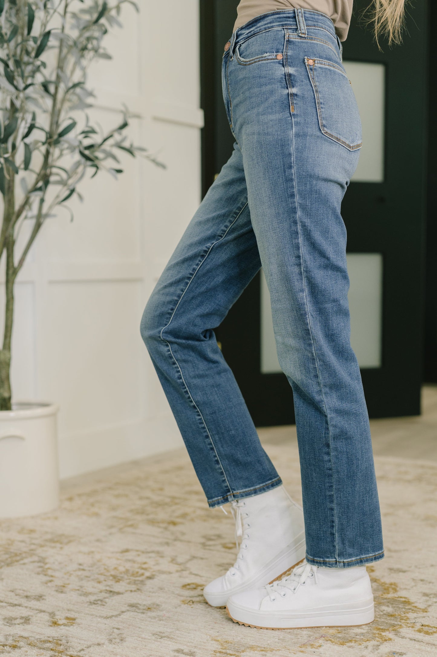 Side angle Judy Blue Izzie high rise straight jeans in medium wash.