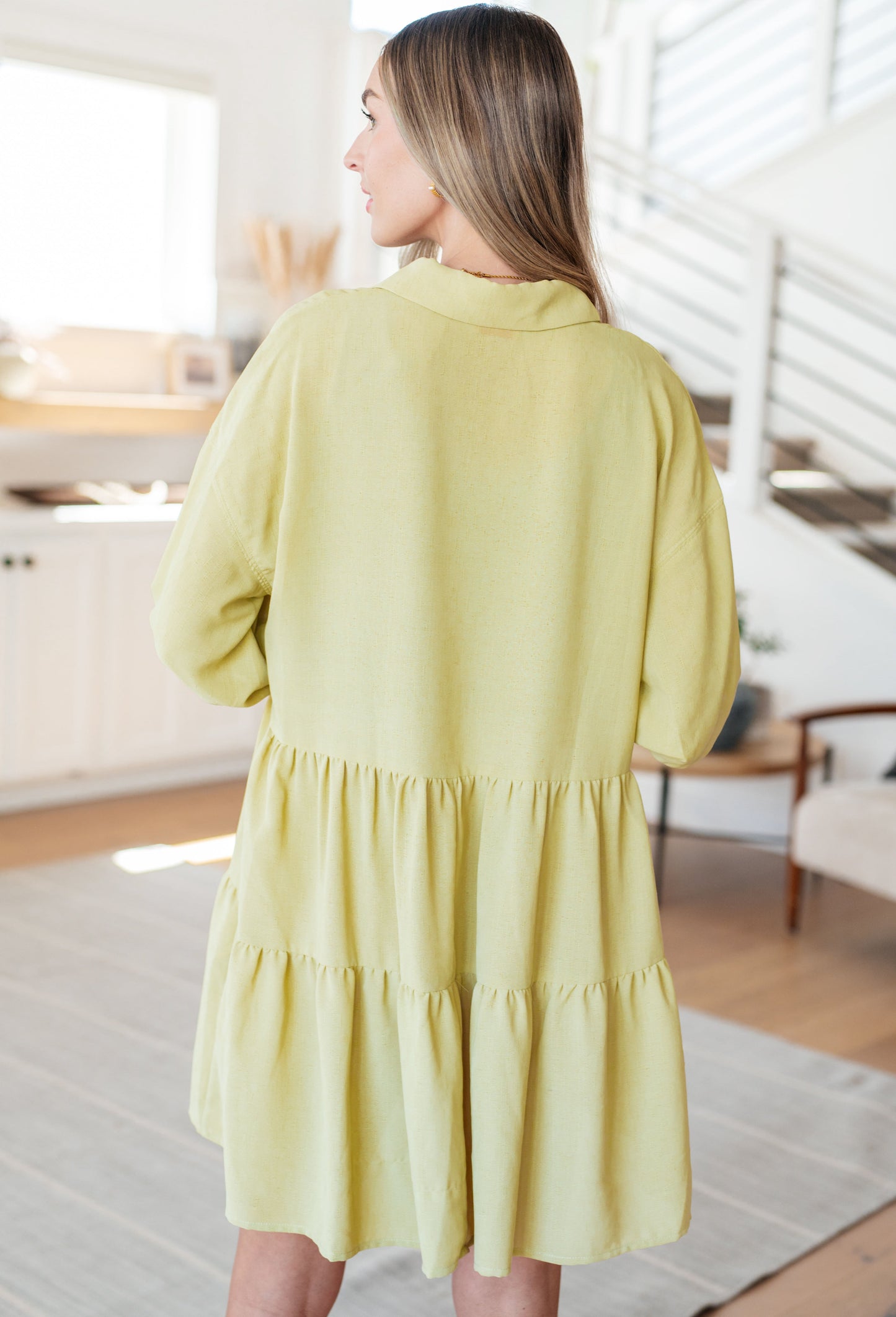 Jessie Tiered Mini Dress in pear green back view with tiered skirt and elastic cuff puffed sleeves.