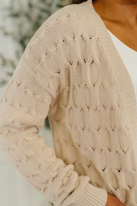 Close up of cable knit texture and ribbed cuff on Juno Cardigan