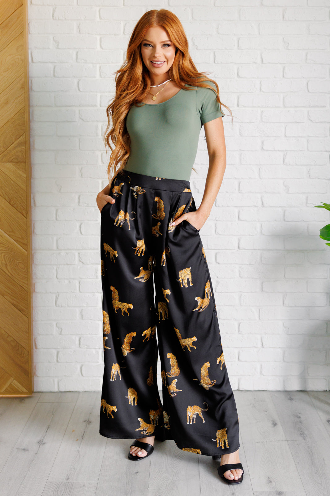 Full body view of Lyra Leopard Satin Wide Leg Pants in shiny satin with bold leopard design, high-rise waist, and wide-leg fit.