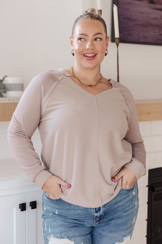 Plus size model in Dominique Beige V-Neck Top, textured knit with raw edge details
