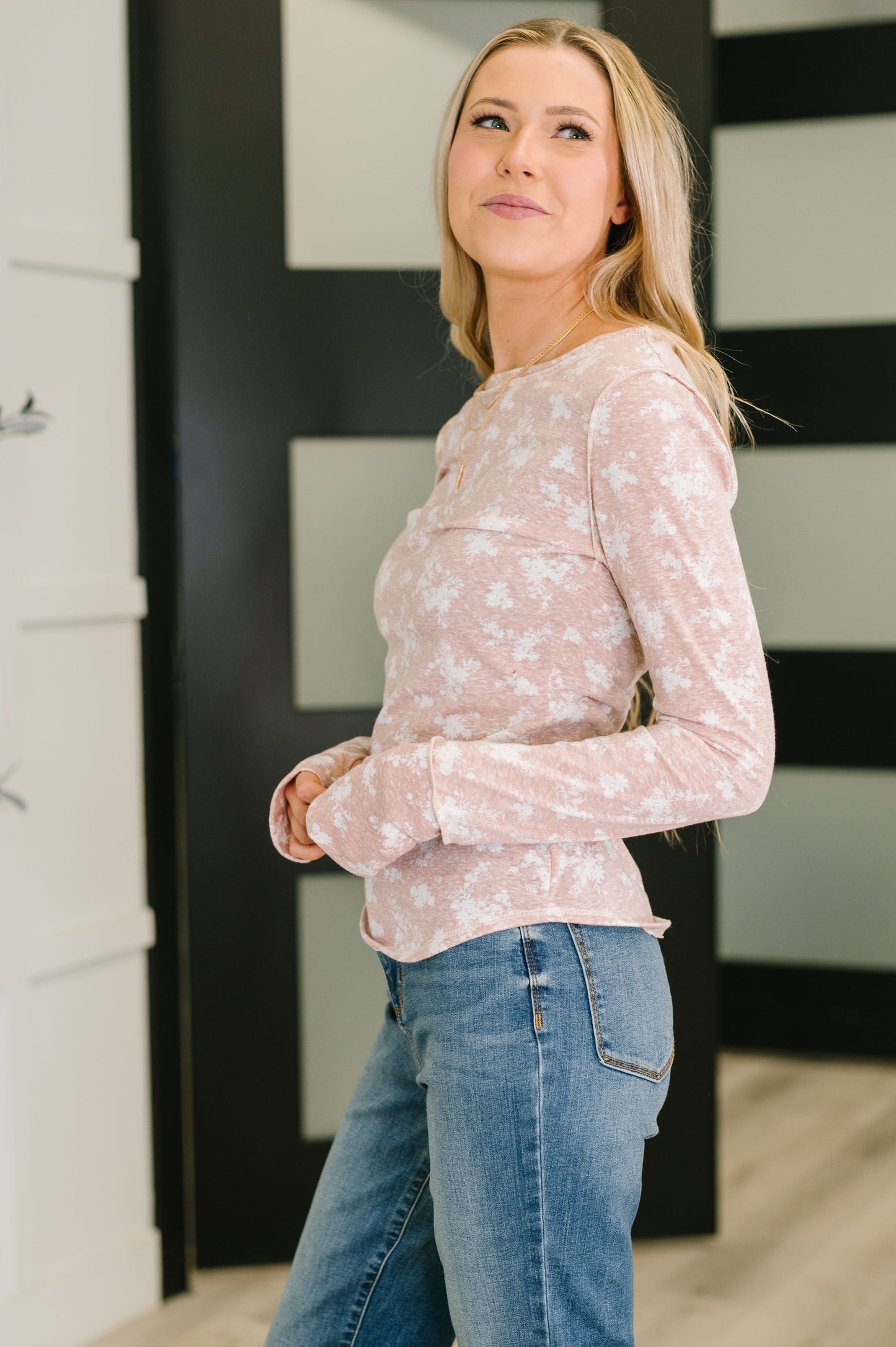Side view of Mara Long Sleeve Top with exposed seams and thumb holes