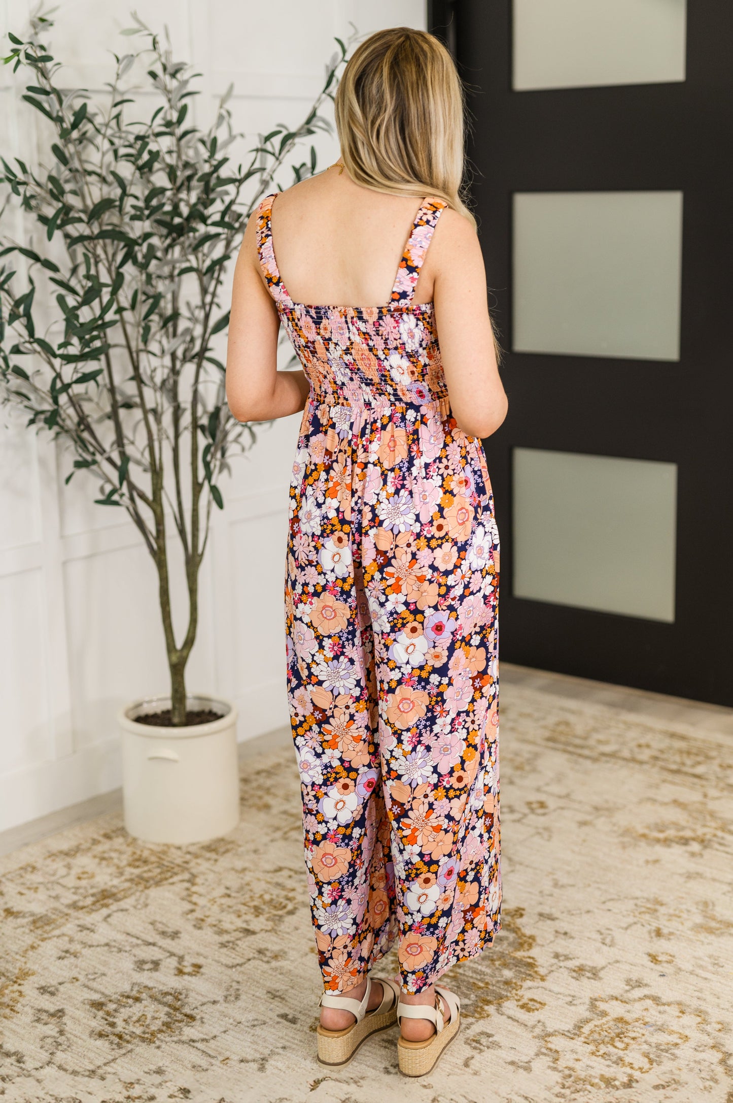 Back view of Livvy jumpsuit with smocked bodice and elastic straps.