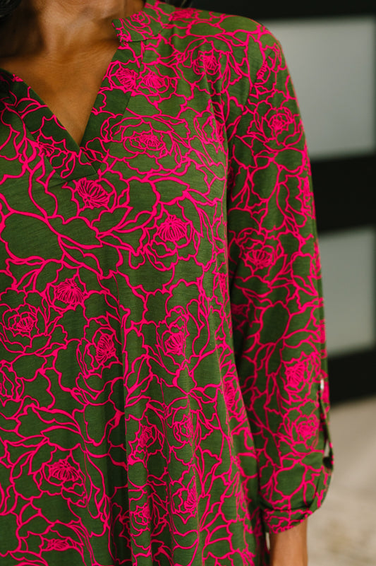 Close-up of Bulgari fabric showing pink floral pattern on olive background of Lizzy Dress.