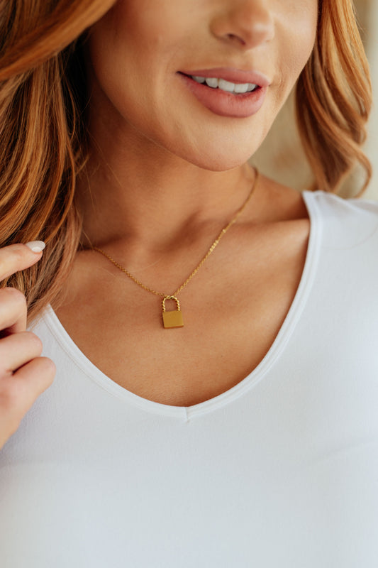 Lena Lock Pendant Necklace on model showing lock pendant detail and delicate chain.