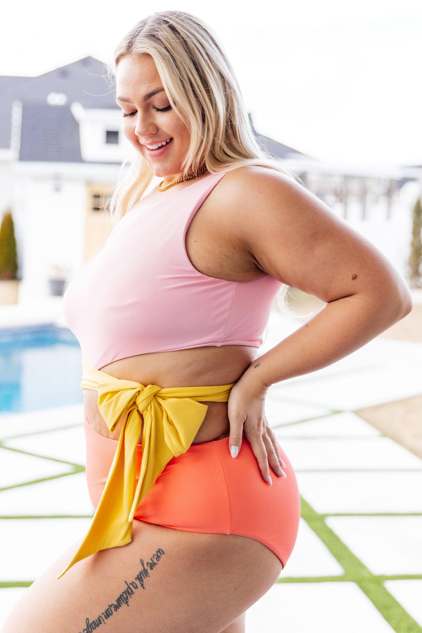 Plus size side view of Long Island Dreams Swimsuit showing off-shoulder neckline, waist tie, and ribbed texture.