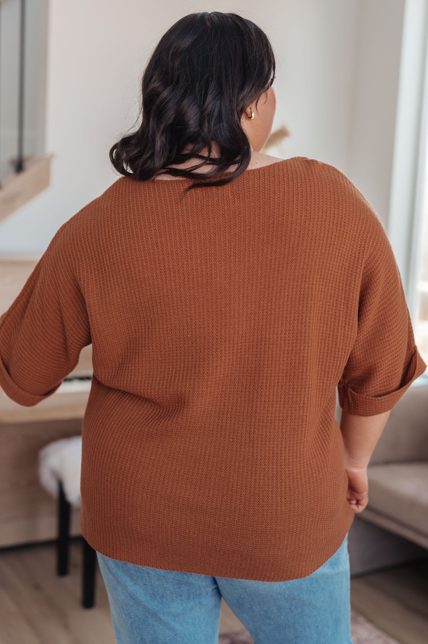 Back view of plus size model in Zizi Rust Sweater Top, relaxed knit silhouette in warm rust color