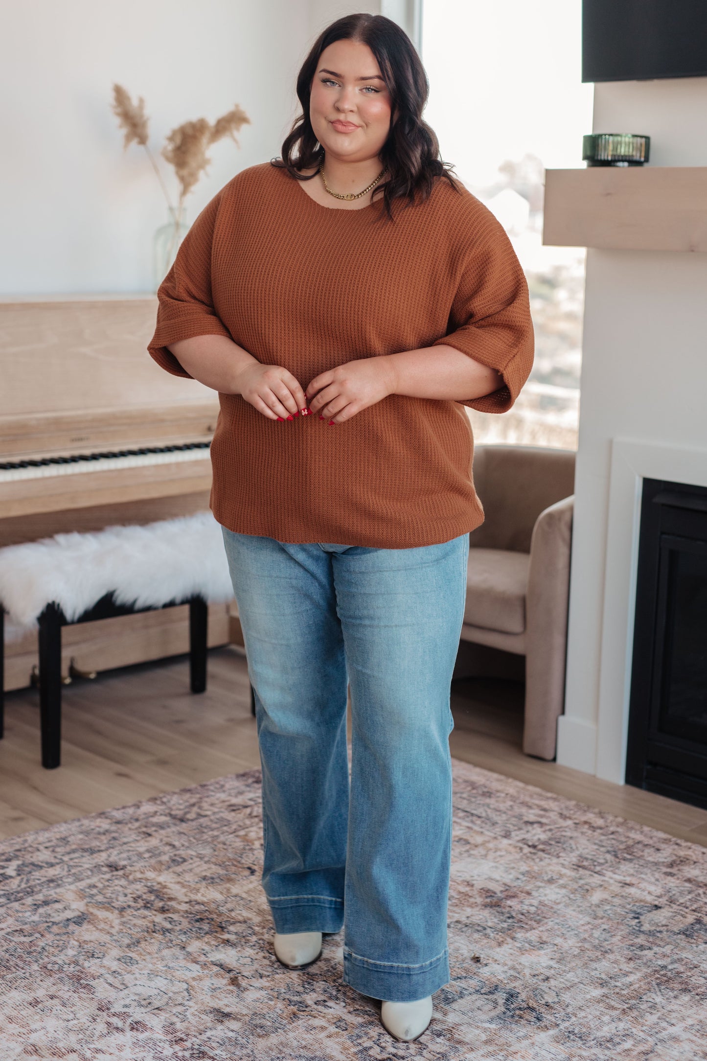 Plus size model styled in Zizi Rust Sweater Top full body, cozy fall knit with relaxed silhouette