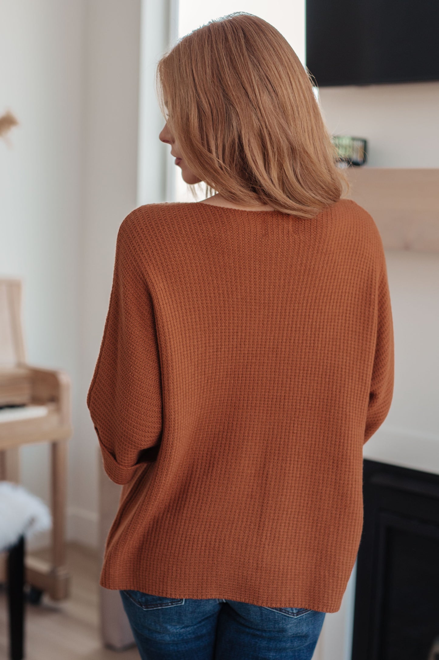 Back of Zizi Knitted Sweater Top in rust, sweater knit with dolman sleeve design