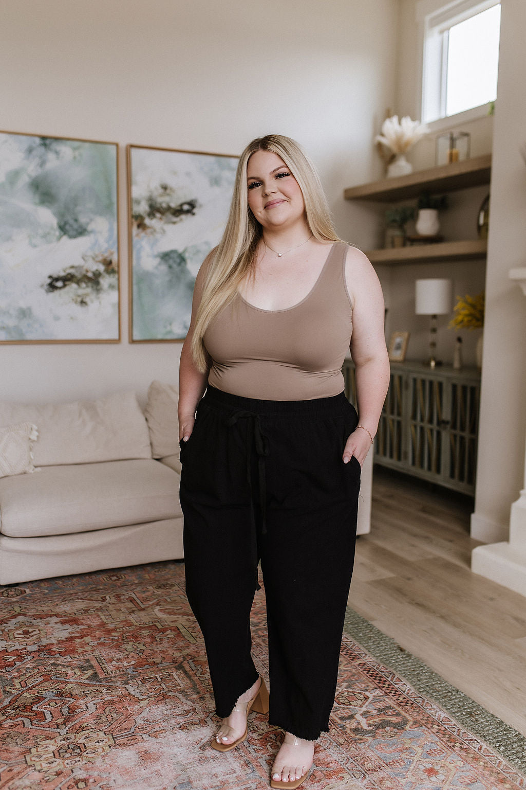 Full body plus size model in Taryn High Waisted Pants, relaxed fit with raw hem and black drawstring waistband