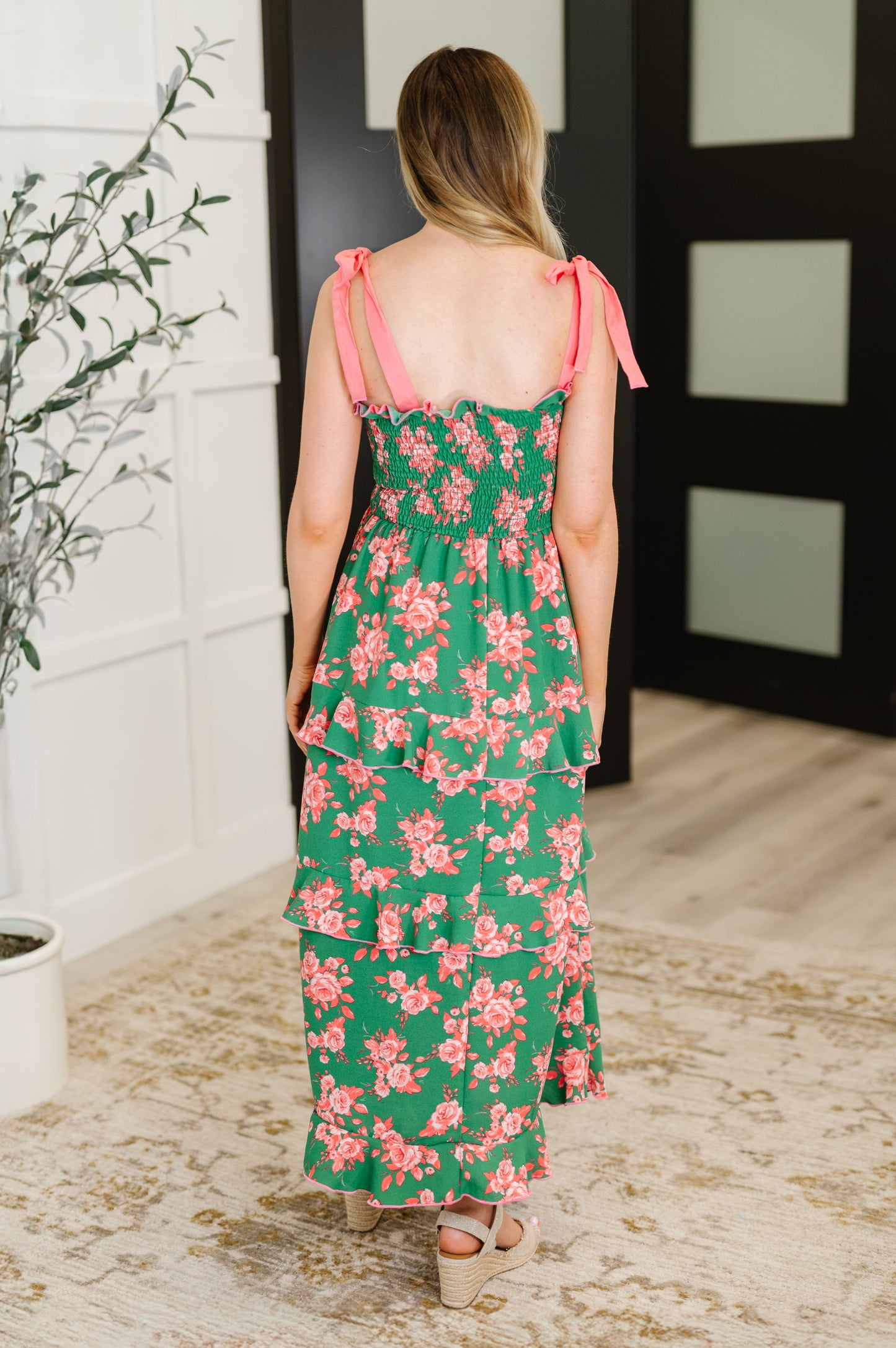 Back view of Lowa Tiered Floral Dress with smocked bodice, adjustable straps, and tiered green and coral floral layers.