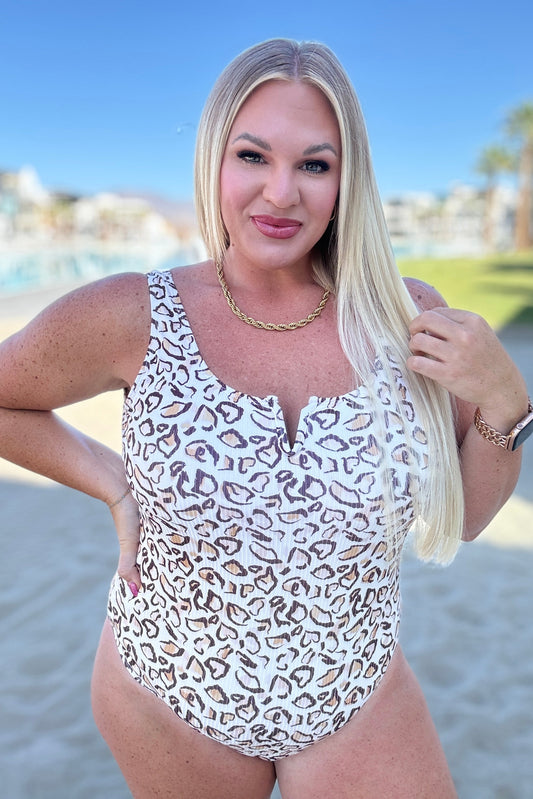 Plus size model in Madagascar Ribbed Swimsuit, cheetah print with ribbed texture, notched neckline, and secure fit.