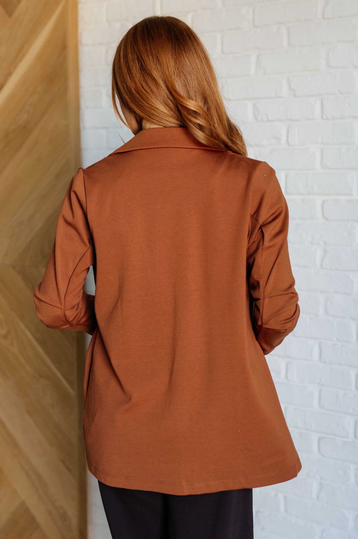 Back view of rust ponte knit Devi Magic Blazer with flattering silhouette.
