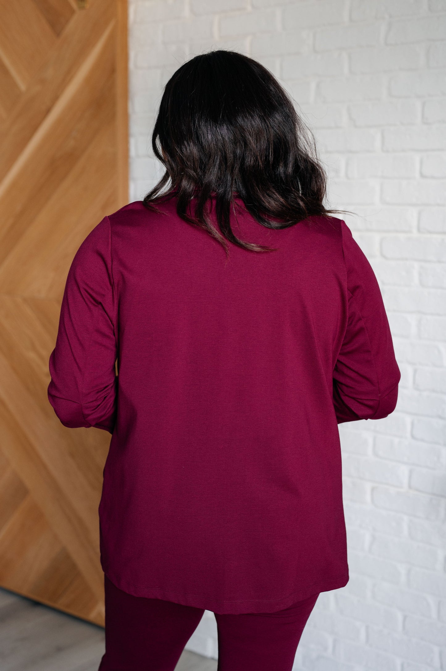 Back view of plus size Devi Blazer in wine with ruched sleeves and chic slim fit.