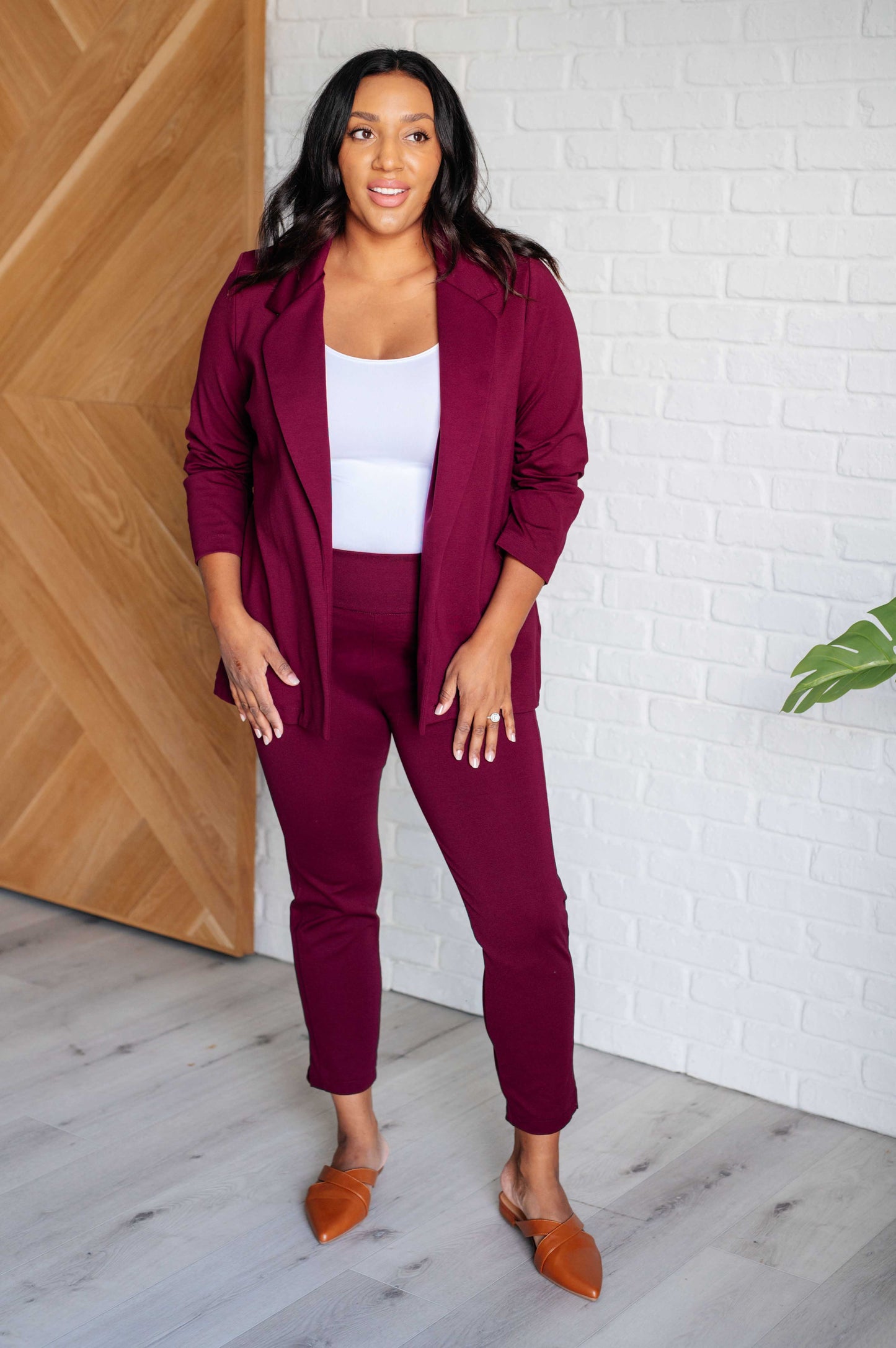 Plus size full body view of Midge Magic Skinny Pants in wine with ankle crop length and tuxedo stripe accent for chic style.