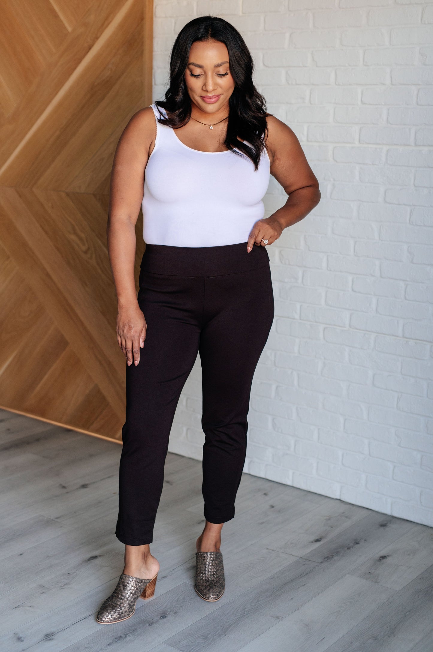 Skinny Pants in Chocolate, high-rise, slim-fit ponte knit fabric with tuxedo stripe, faux welt pockets, and ankle crop. Features elastic waistband and cuff slit.