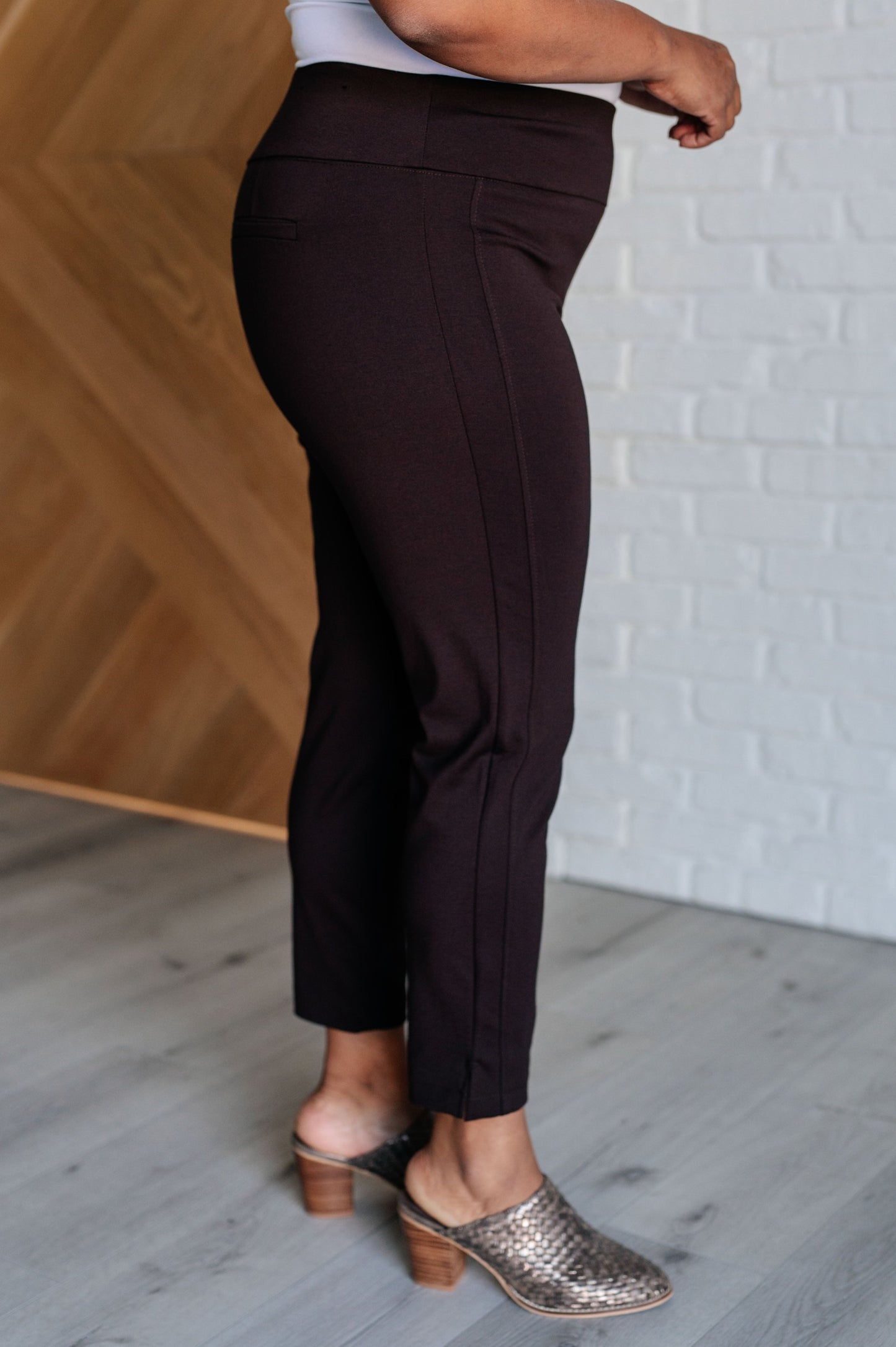 Skinny Pants in Chocolate, high-rise, slim-fit ponte knit fabric with tuxedo stripe, faux welt pockets, and ankle crop. Features elastic waistband and cuff slit.