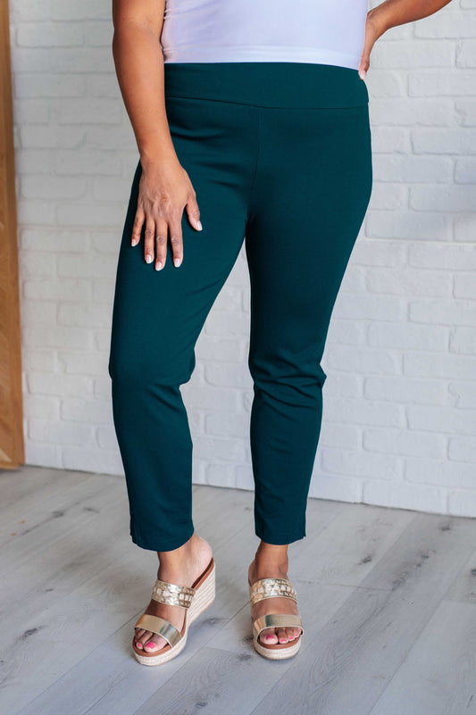 Plus size model in Hunter Green Midge Magic Skinny Pants, flattering high-rise and chic slim fit.