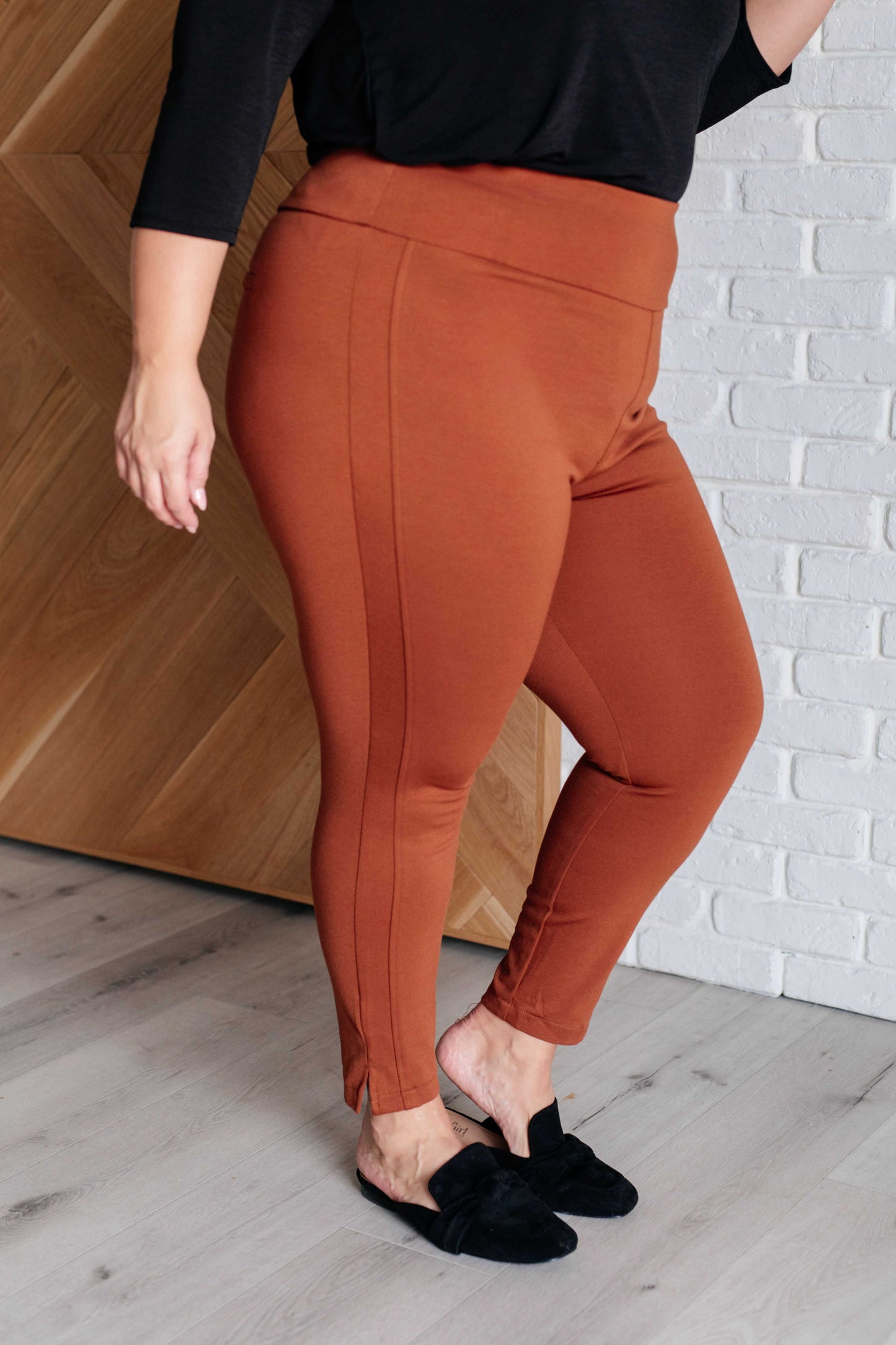 Plus size side view of Rust Midge Magic Skinny Pants with chic tuxedo stripe and flattering ankle crop design.