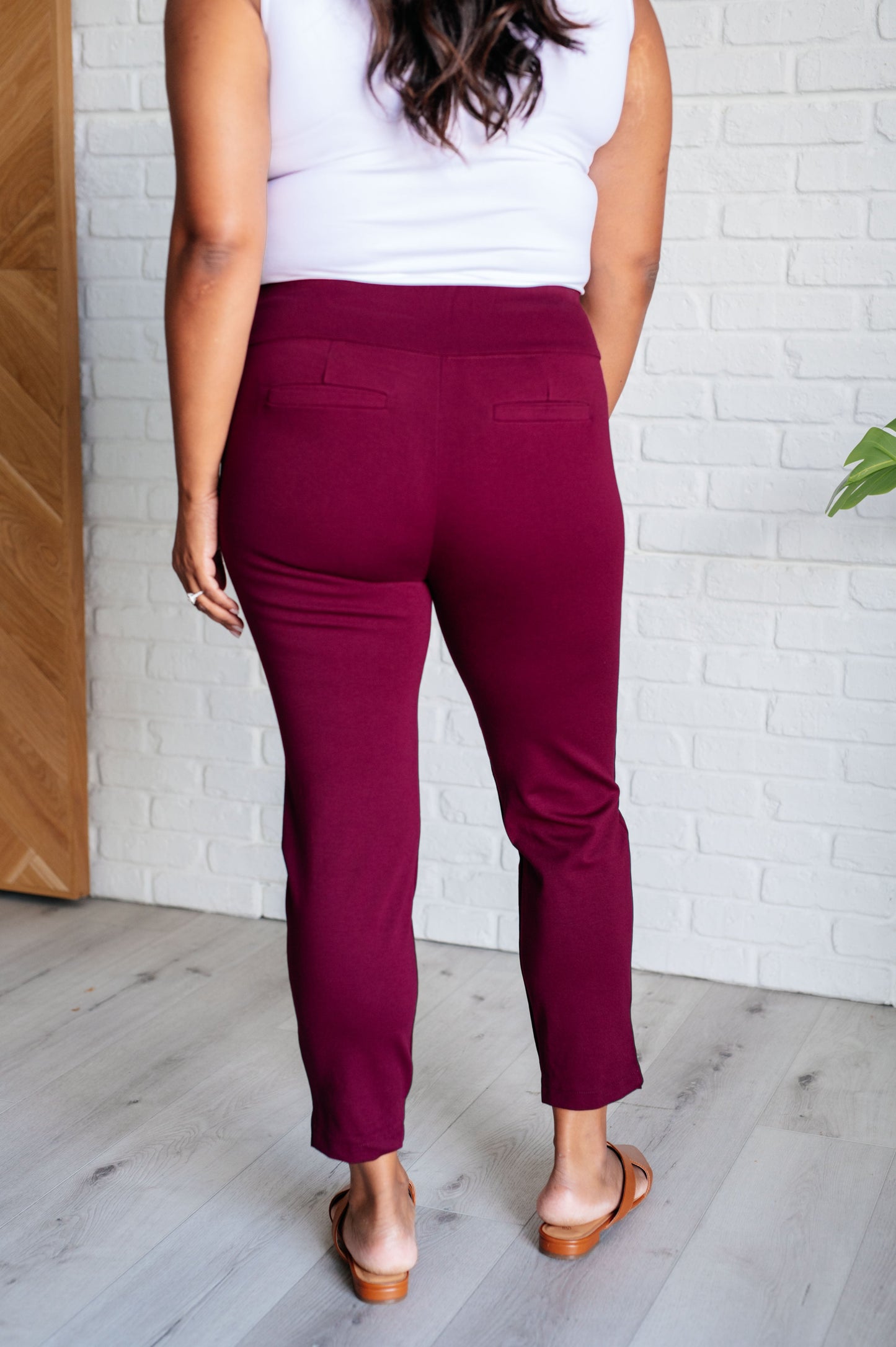 Plus size back view of Midge Magic Skinny Pants in wine with slim fit, tuxedo stripe, and flattering high-rise waistband.