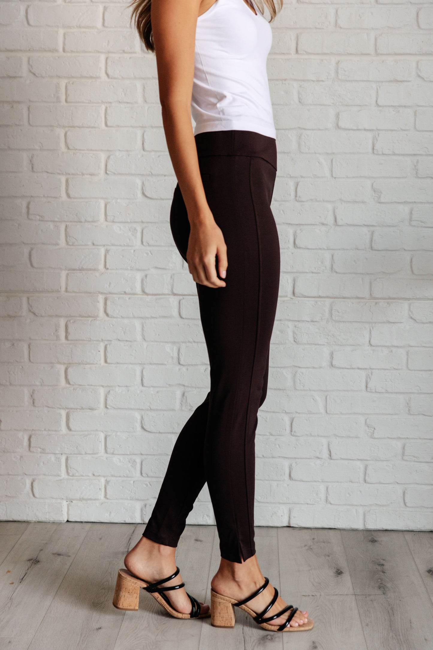 Side view of chocolate skinny pants highlighting tuxedo stripes, slim cut, and comfortable ponte knit.