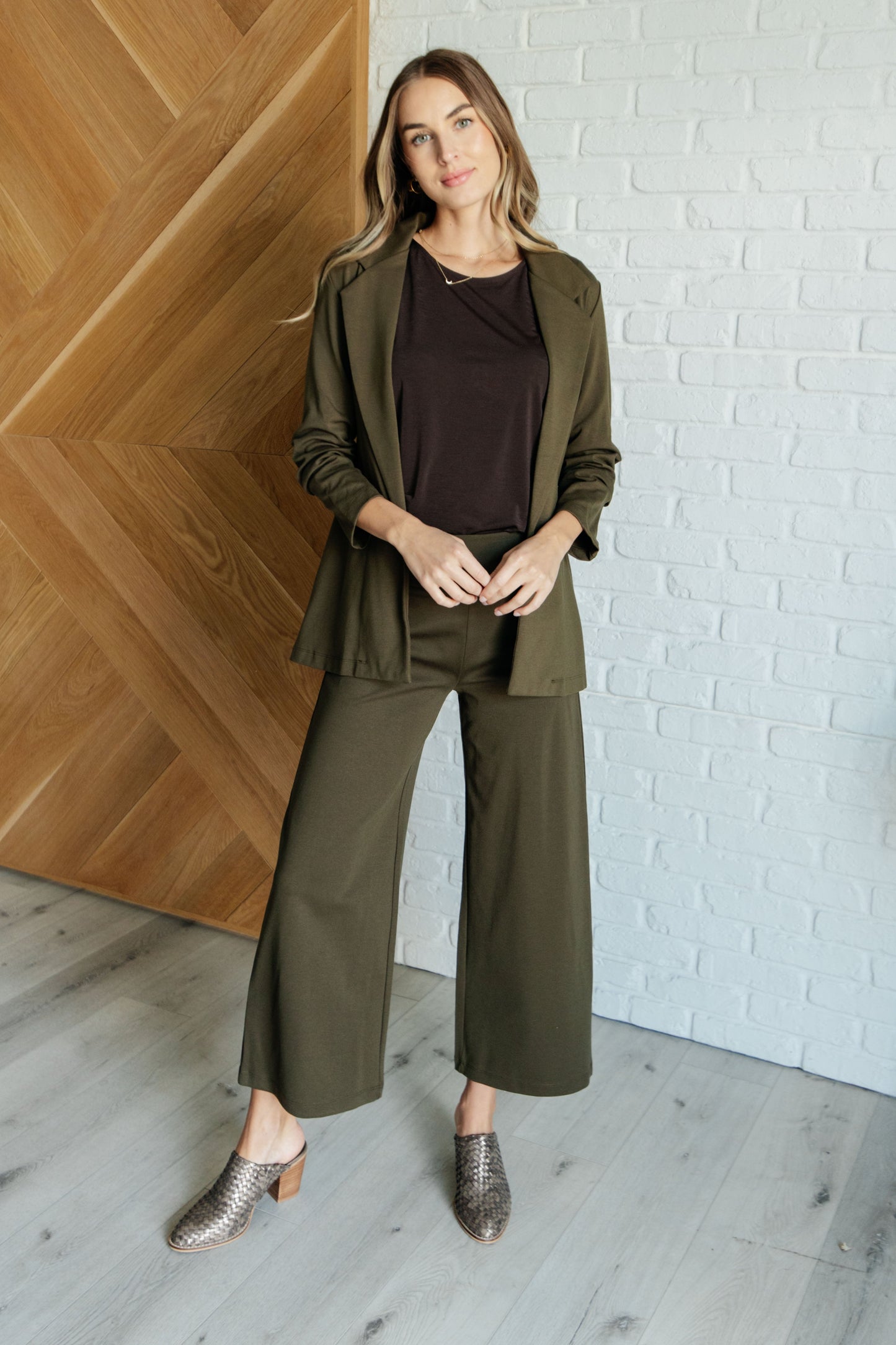 Olive ponte knit wide leg crop pants styled with blazer, cropped cut, high-rise waist, versatile polished look.