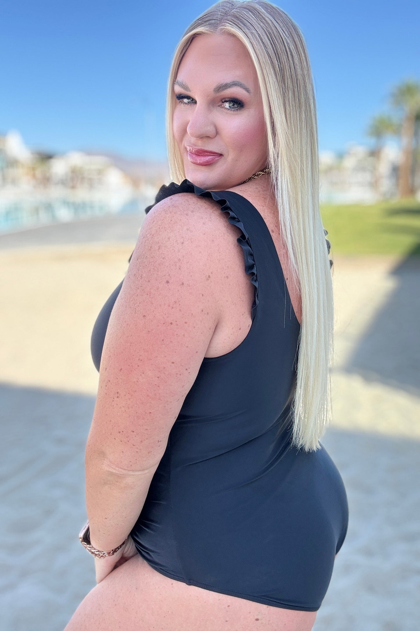 Side view of plus size Maldives Ruffle Swimsuit showing ruched detail and flattering fit.