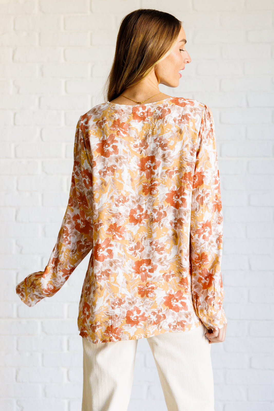 Back view of Marigold Floral Blouse with flowy crinkle woven fabric