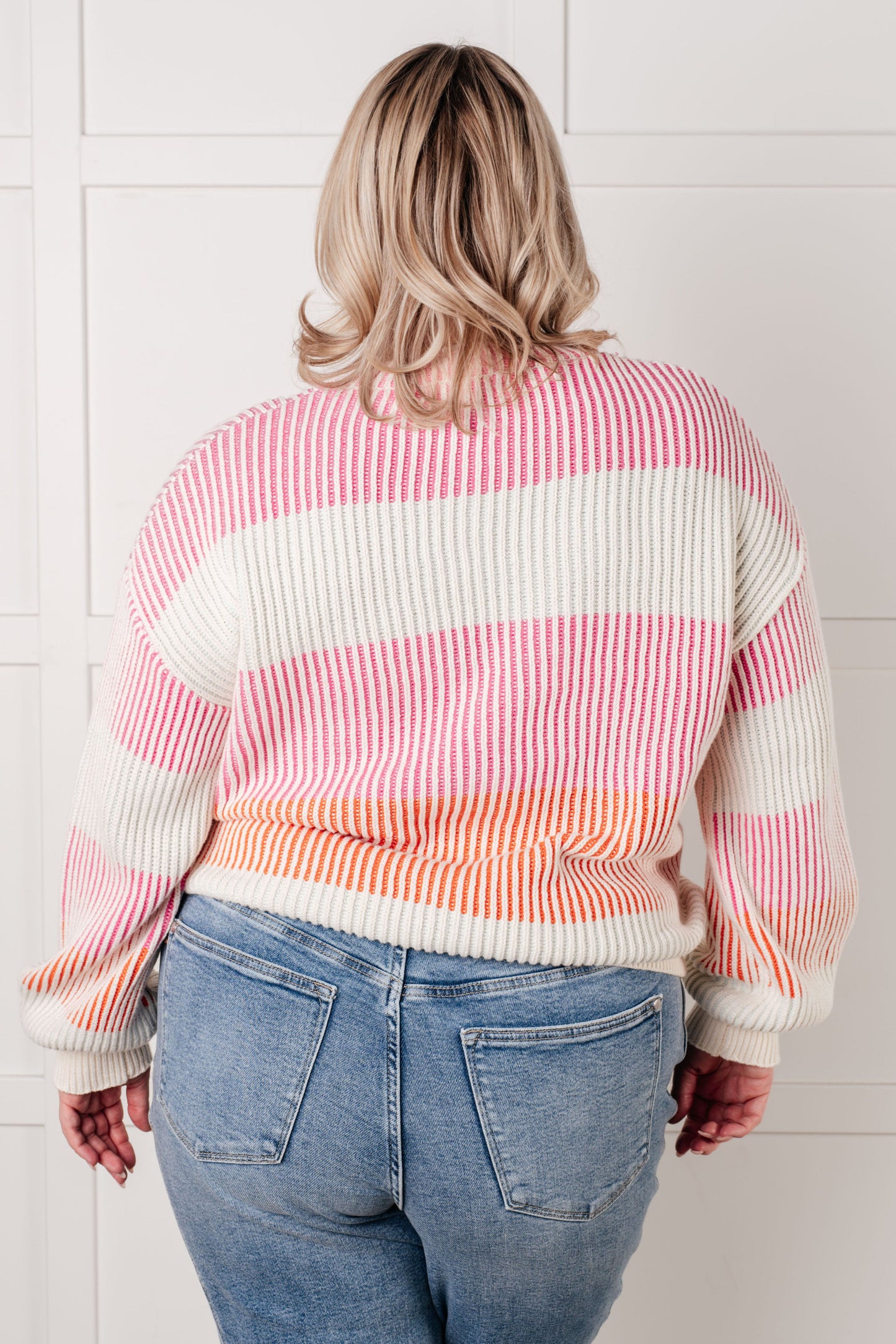 Plus size model back view in Edie Striped Ribbed Sweater, textured knit with vibrant stripe pattern
