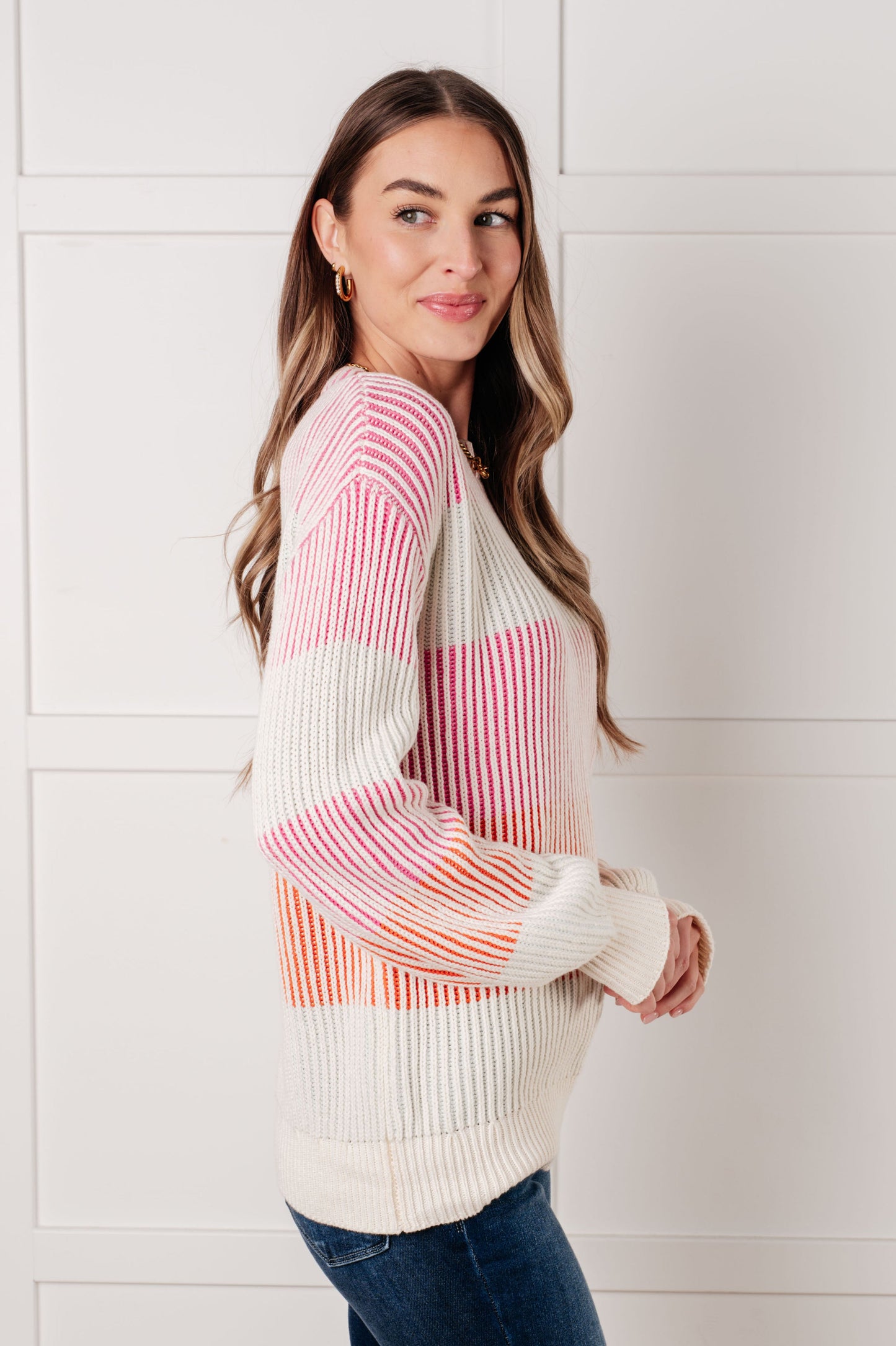 Side profile of Edie Striped Ribbed Sweater showing balloon sleeve and striped knit design