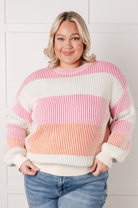 Plus size model in Edie Striped Ribbed Sweater, vibrant striped knit with banded cuffs and hemline