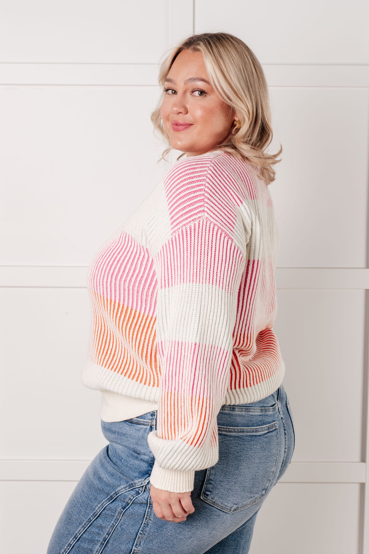 Plus size model side view in Edie Striped Ribbed Sweater with bold stripes and relaxed fit