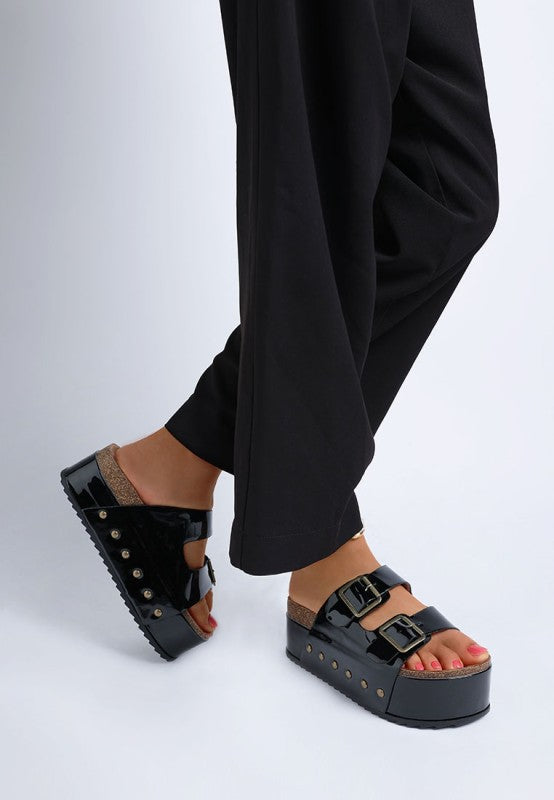 Lifestyle shot of black Merton Studded Flatform Slip Ons paired with casual wear, bold stud accents and chunky sole.