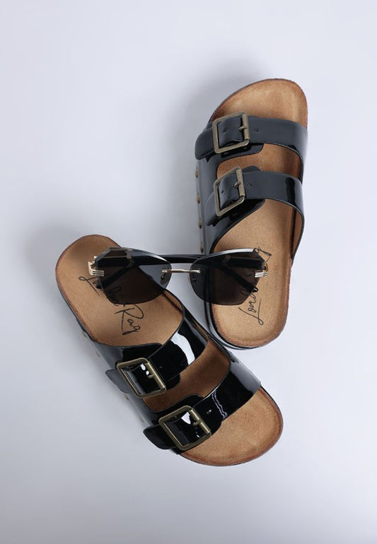 Top view of Merton Studded Flatform Slip Ons showing round open toe design, edgy studs, and glossy black patent look.