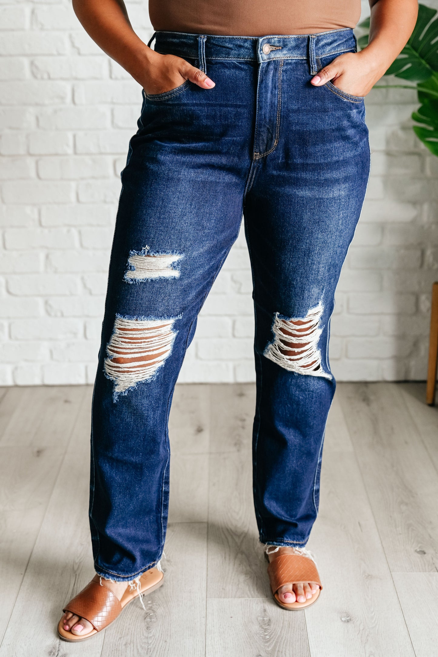 Plus size model in Montana High Rise Distressed Jeans, front view.