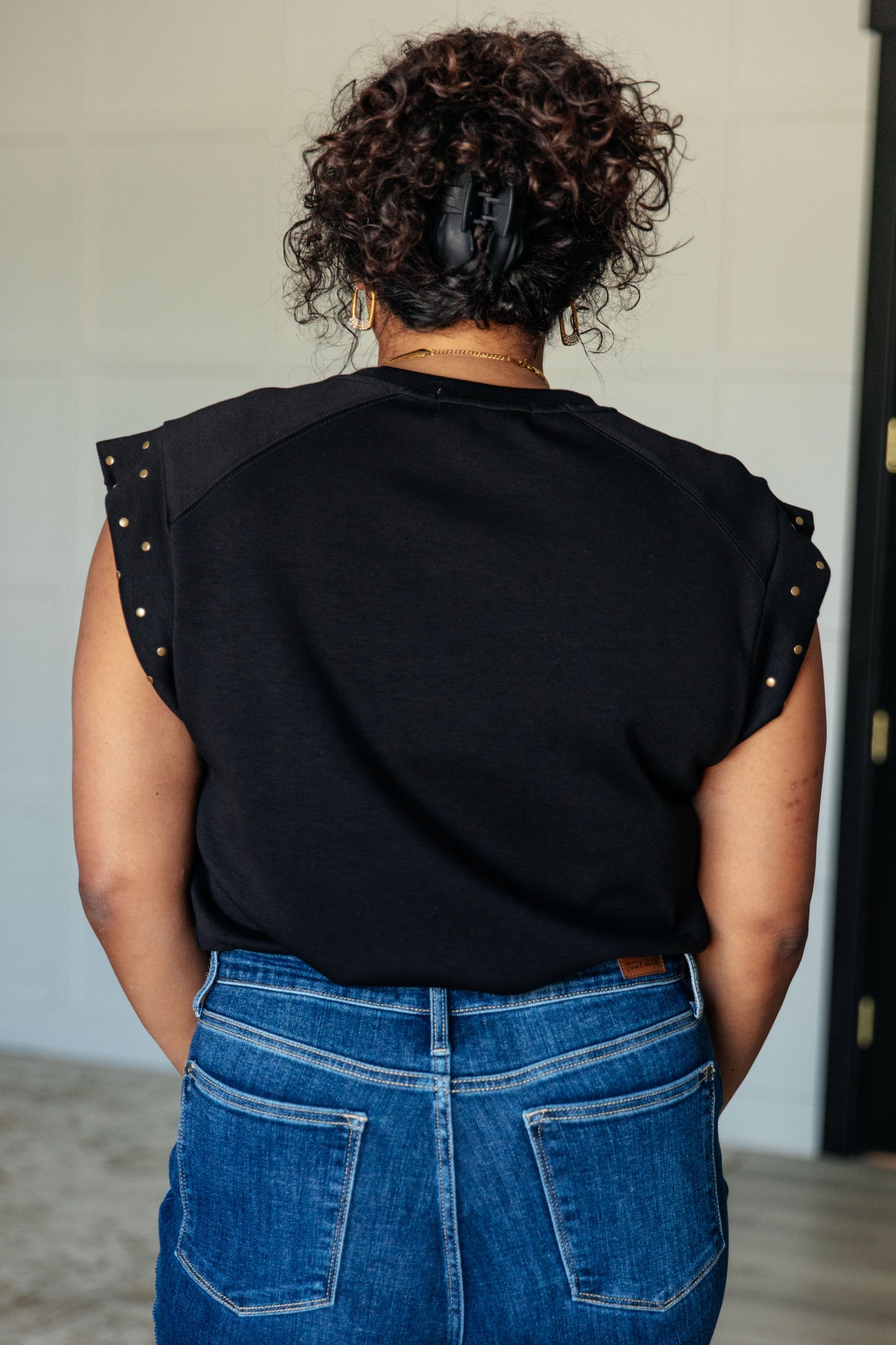 Plus size model back view in Myla Studded Cap Sleeve Top highlighting sleek fit and cap sleeves.