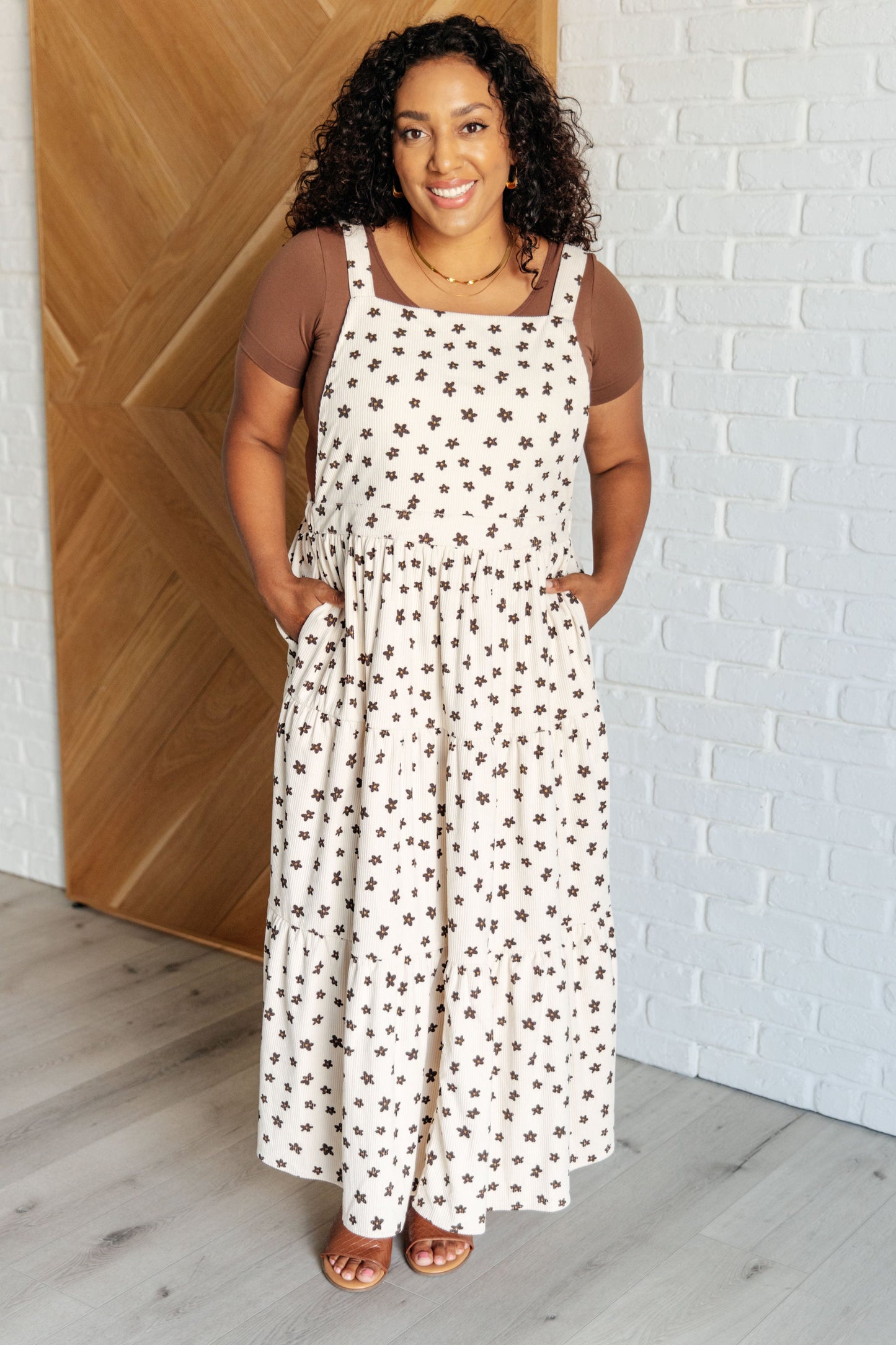 Plus size model wearing Nat Flower Corduroy Dress, floral tiered design with pockets.