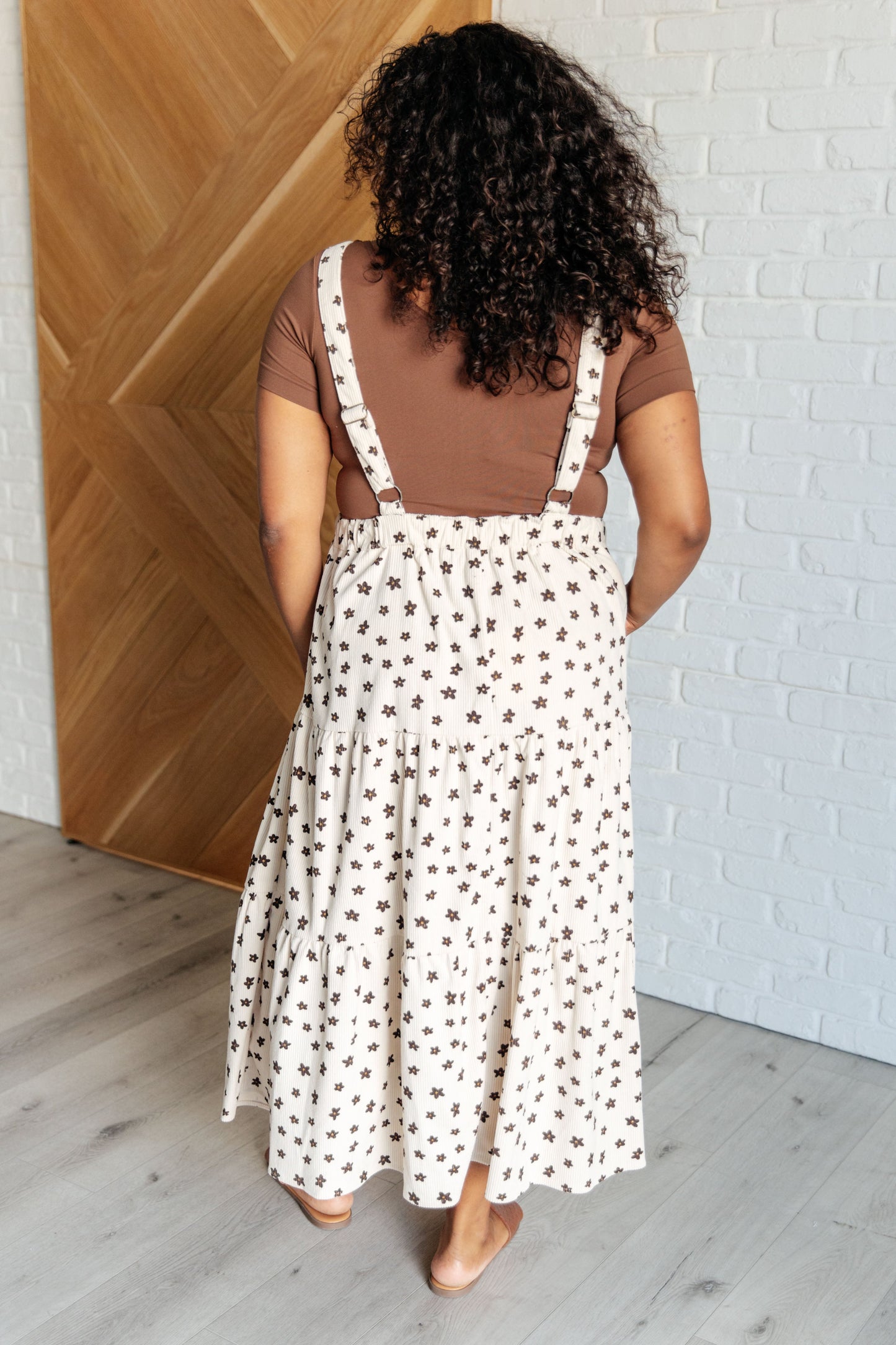 Back view of plus size model in Nat Flower Dress with elastic cased backing.