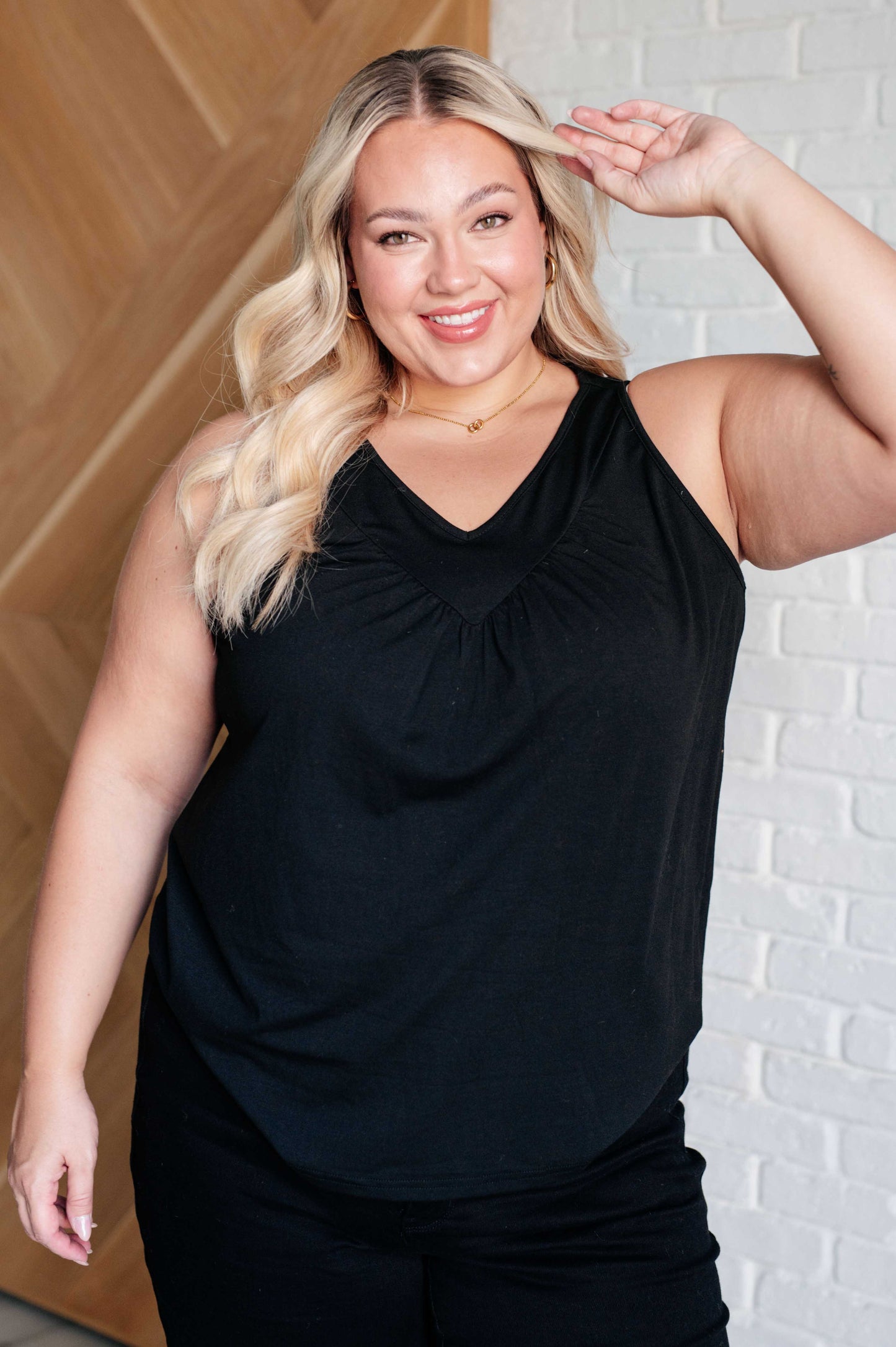 Plus size model in Nala Black V-Neck Tank showing flattering neckline and ruched detail.