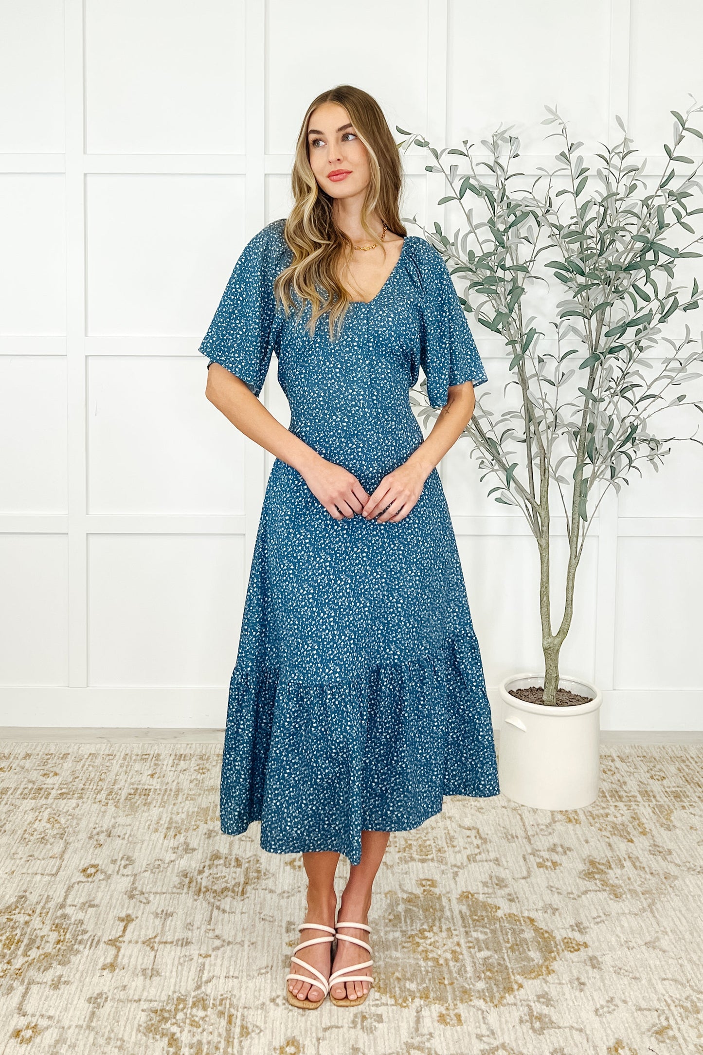 Front view of Olive Blue Floral Dress with scooped neckline, raglan sleeves, and functional zip front.