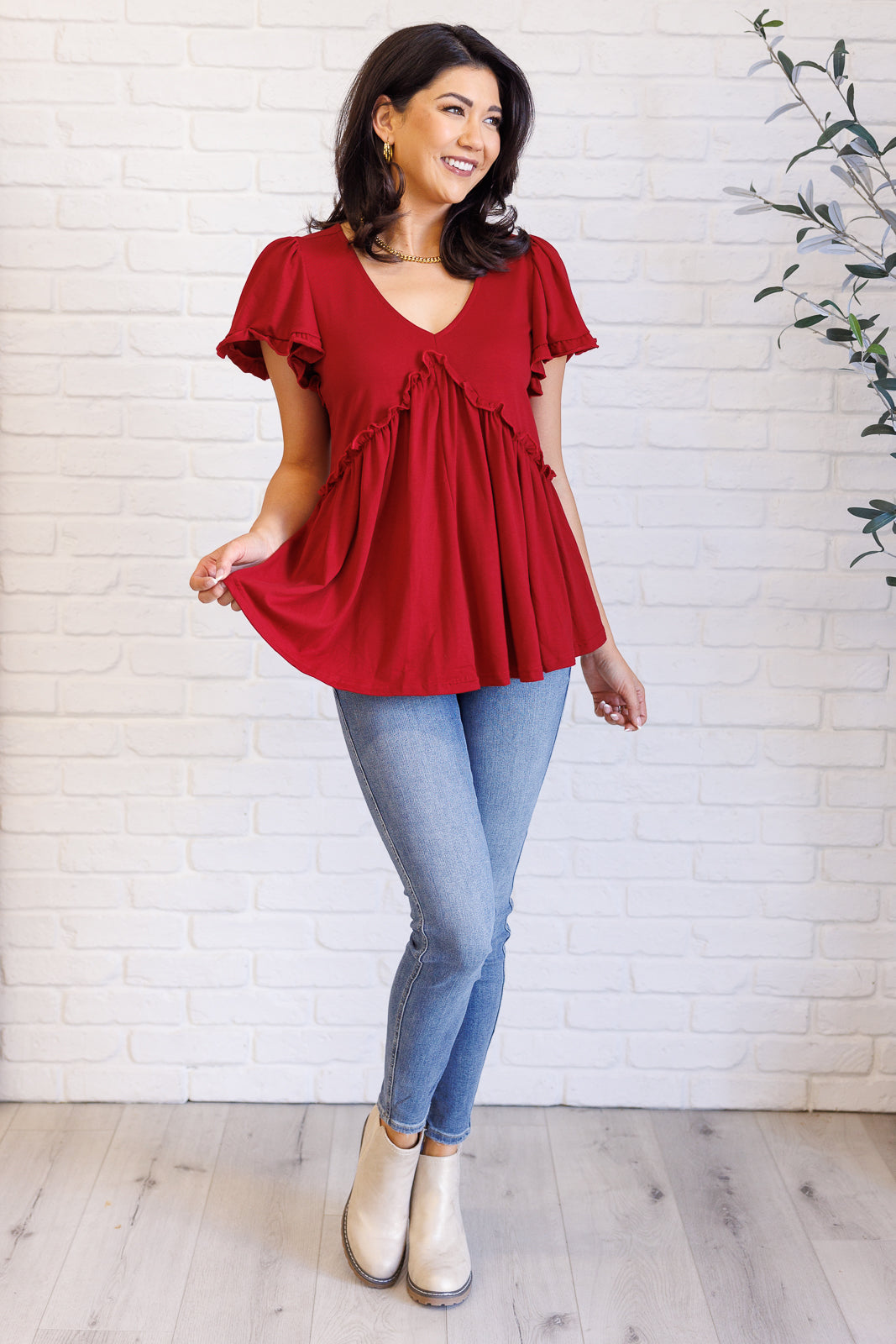 Full body view of Wesleigh V-Neck Ruffle Top in red with feminine ruffle details and relaxed peplum fit.