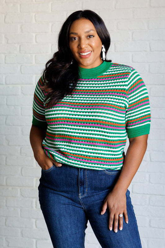 Plus size model in Sitarah Green Striped Knit Top with round neckline and half sleeves.