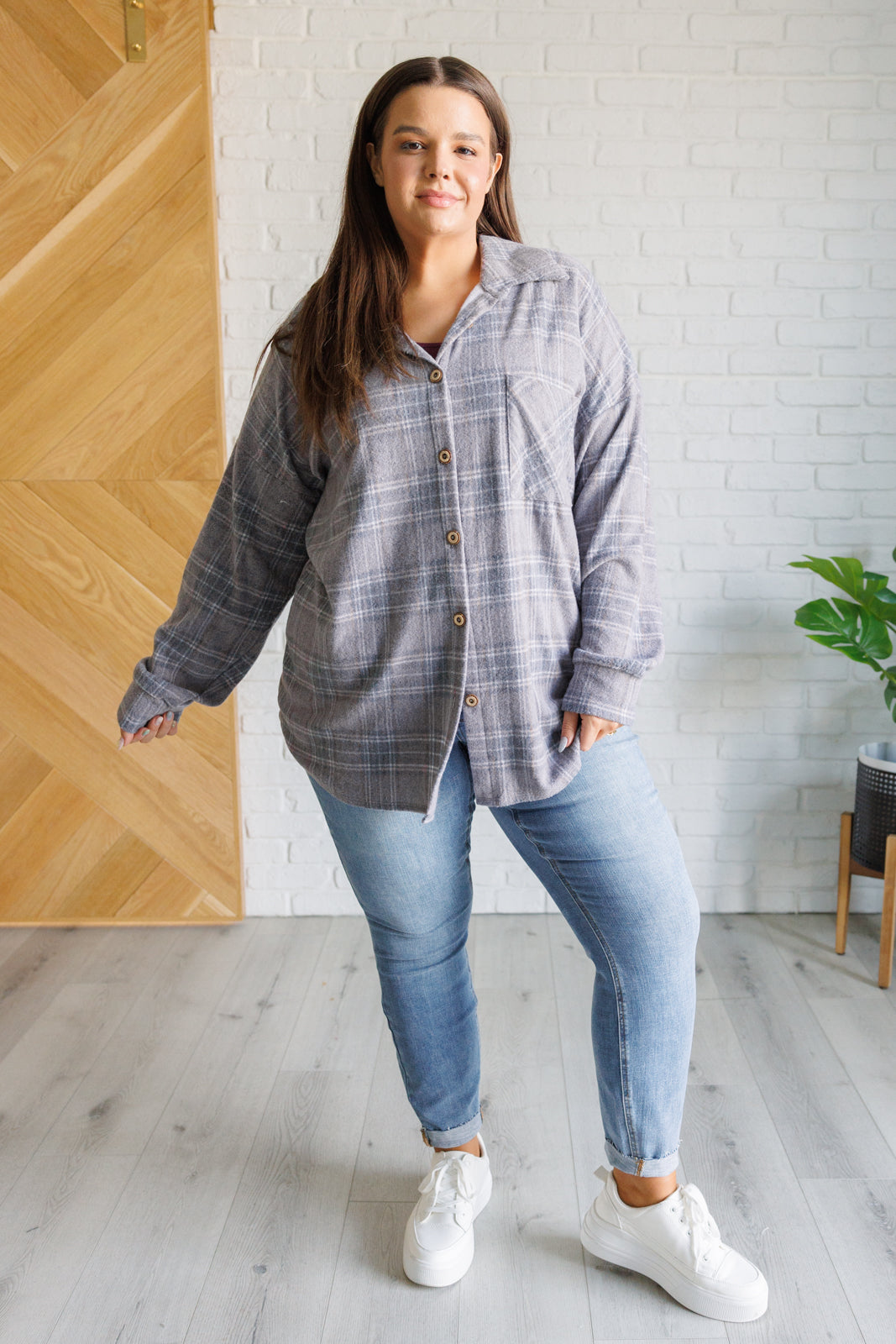 Plus size model wearing Harvey Plaid Button Up in light gray plaid with relaxed styling.