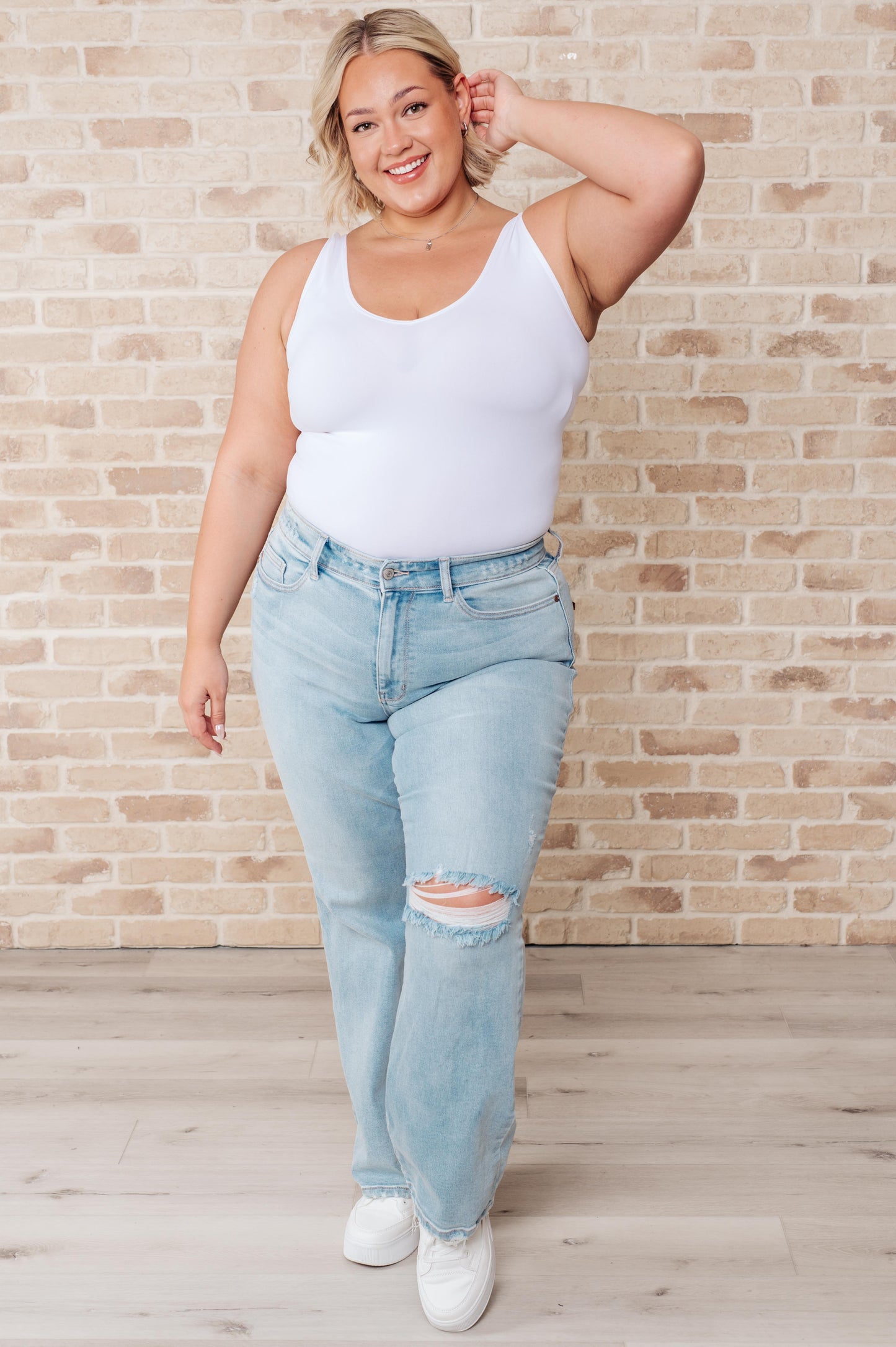 Plus size full body view wearing Parker Judy Blue Straight Jeans, high rise, light wash, and distressed finish.