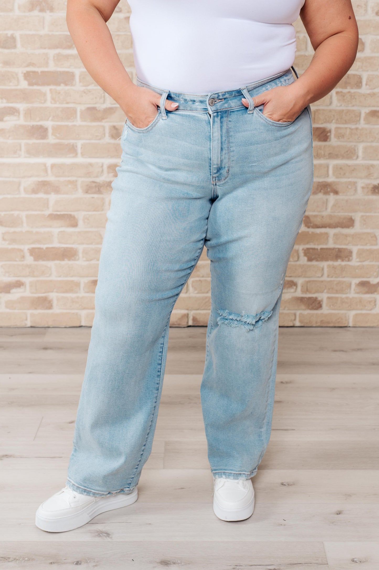 Plus size front view of Parker High Rise 90’s Straight Jeans in light wash with distressed details.